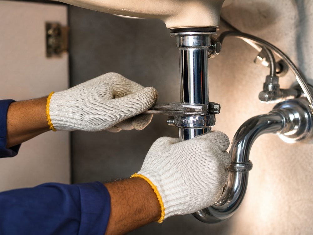 Close-up of a Sameway technician's hands at work